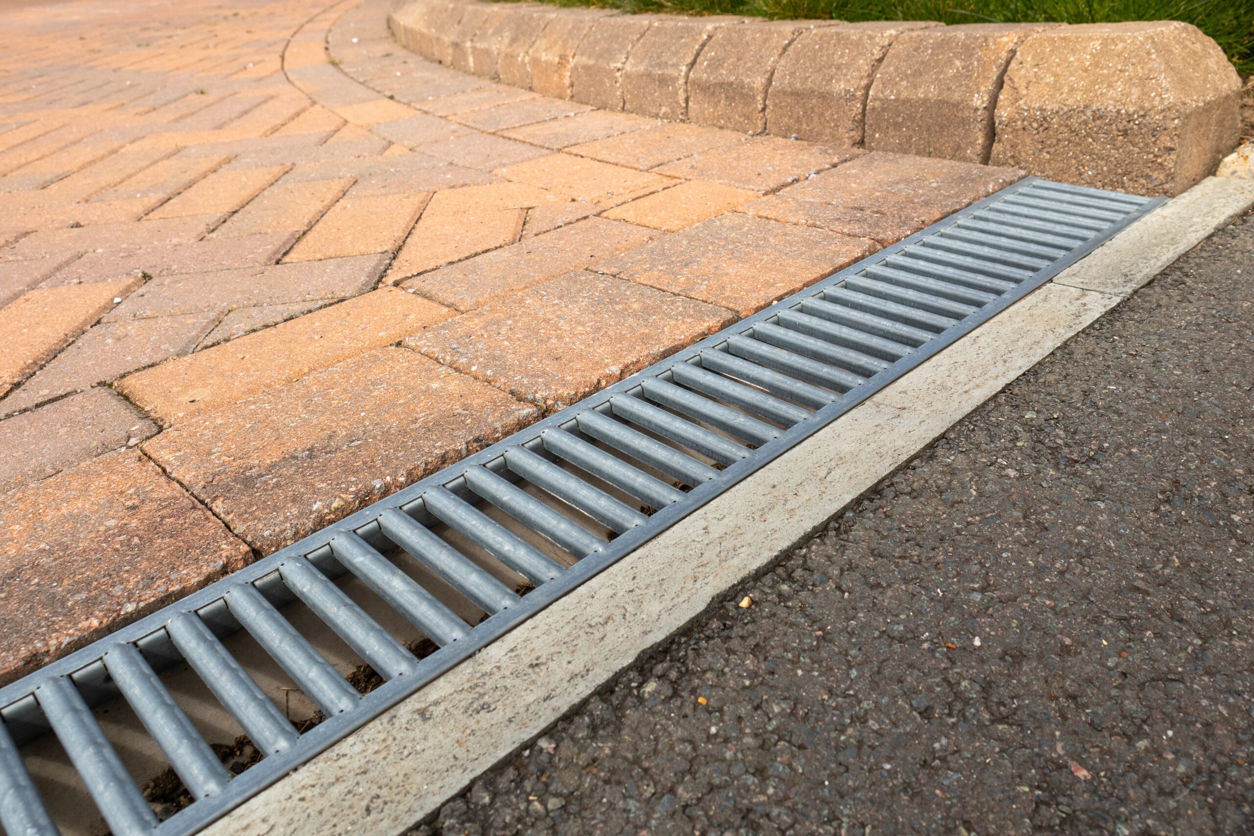 Galvanised,Steel,Drainage,Channel,In,A,Red,Block,Paved,Residential